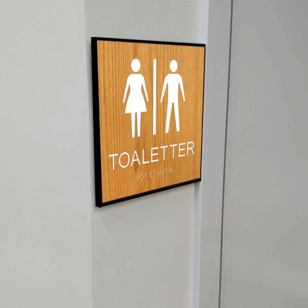 Taktilt piktogram trä med ram Toaletter