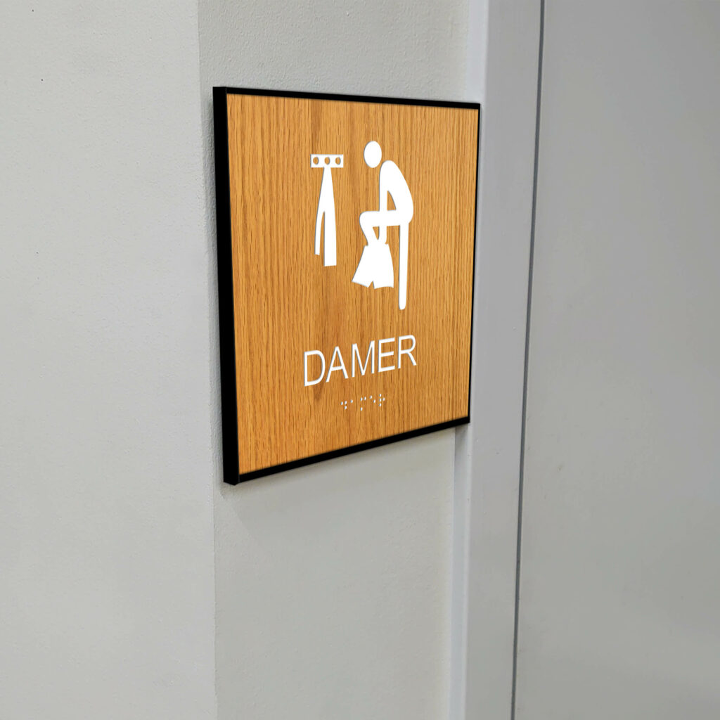 Taktilt piktogram trä med ram Omklädnings Damer