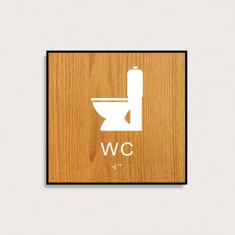 Taktilt piktogram WC i trä med vit symbol med ram